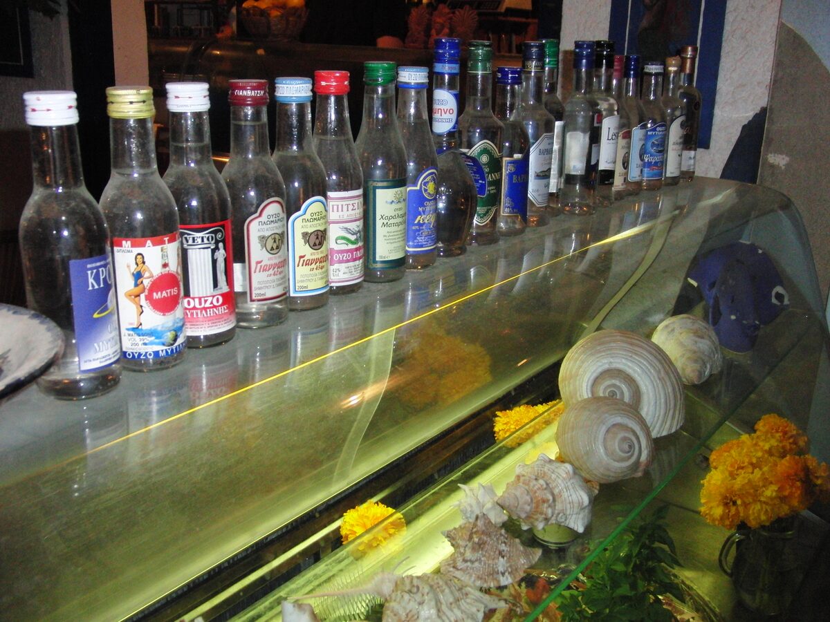 Bottles of ouzo lined up on a bar counter