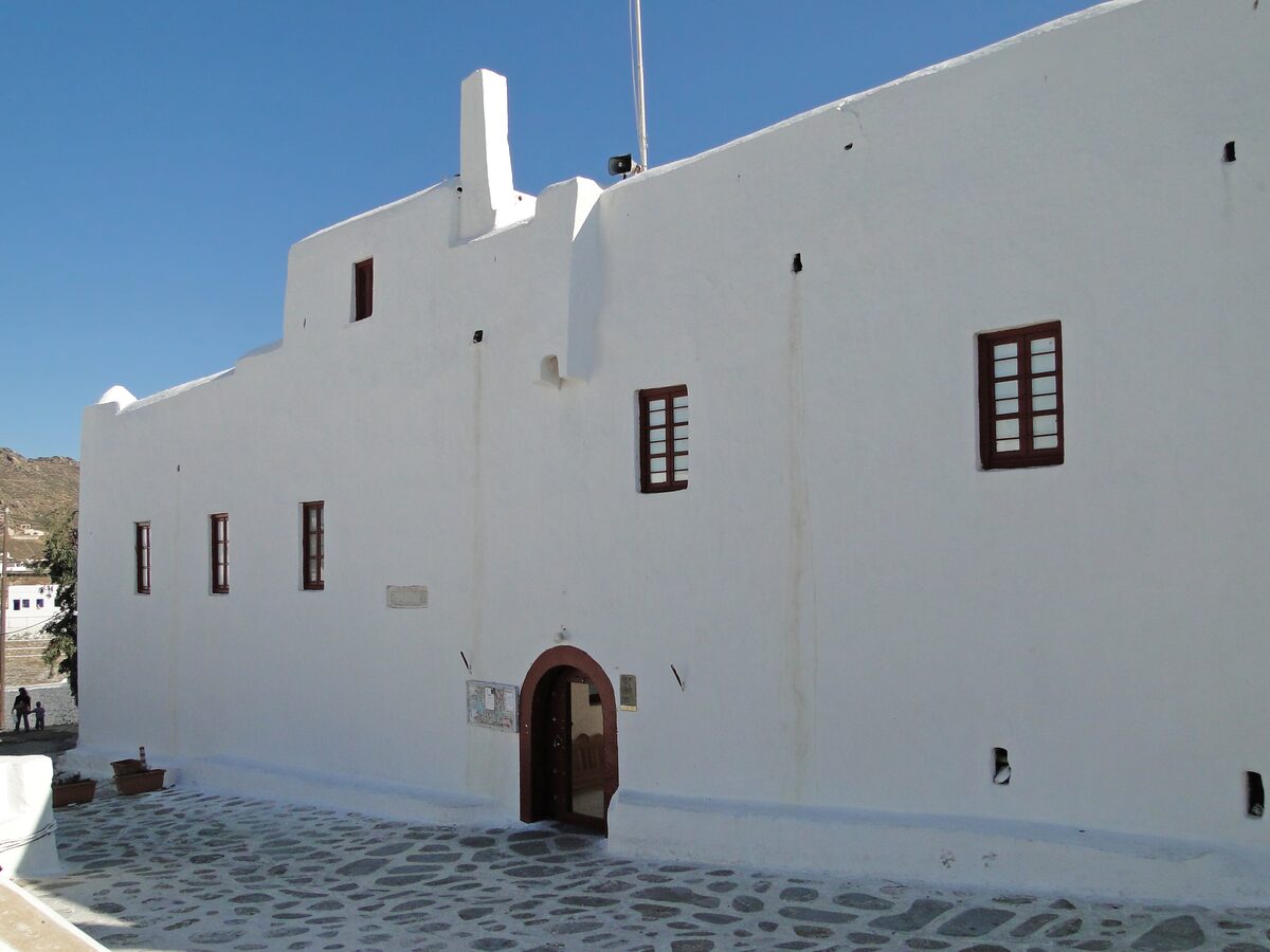 The whitewashed Panagia Tourliani monastery with its arched wooden door