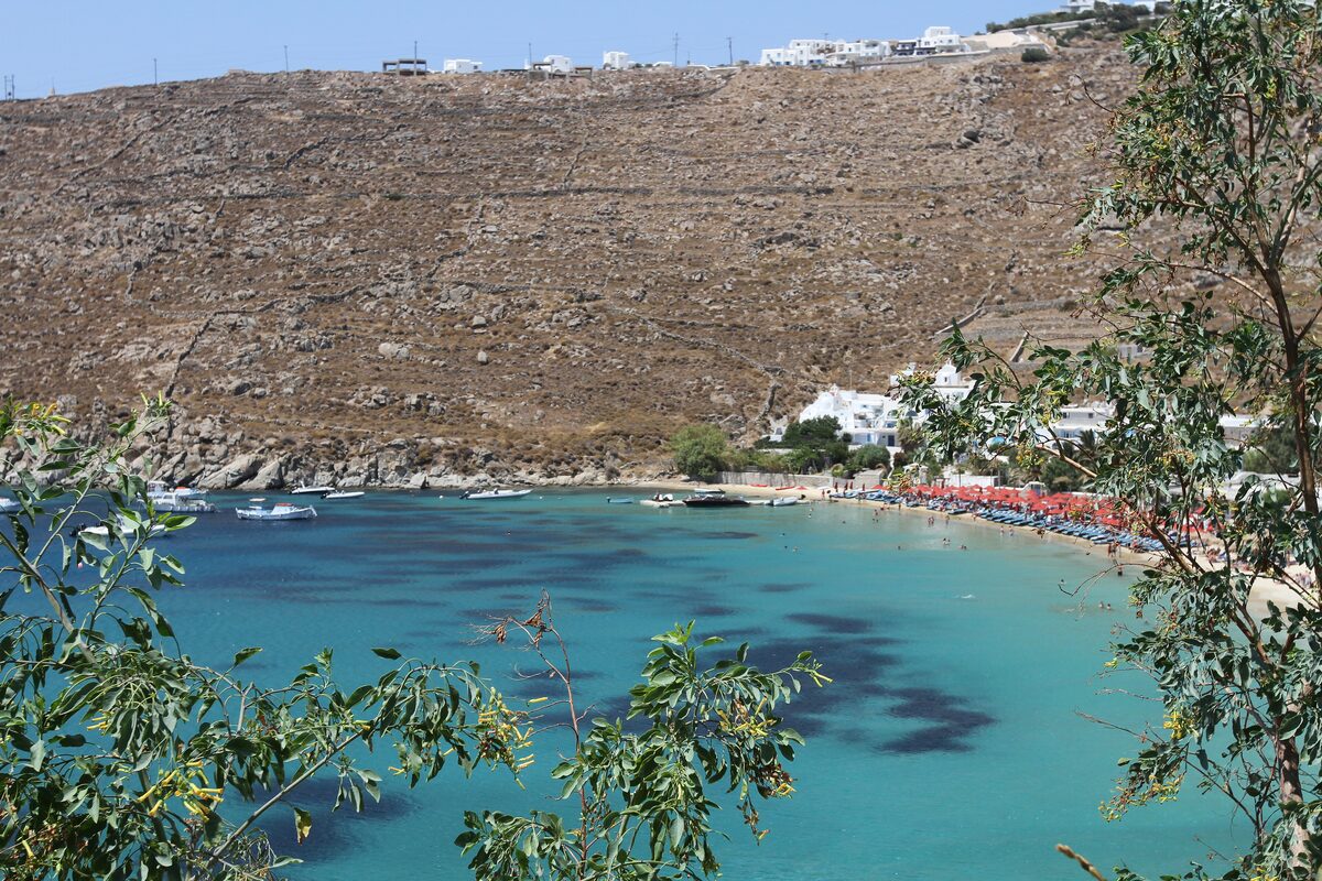 Psarou beach, a small cove of turquoise water below the dry hills