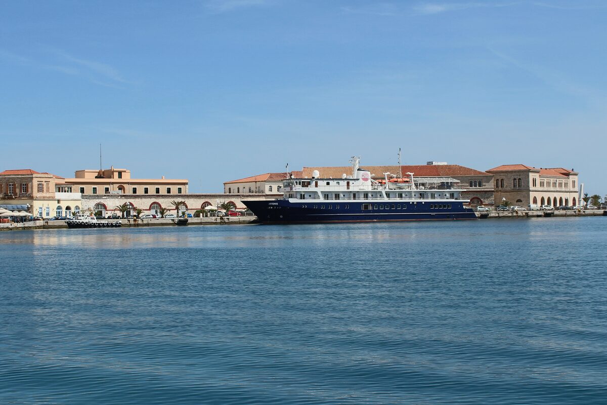 The Ermoupoli waterfront on Syros, with neoclassical buildings and a ferry docked