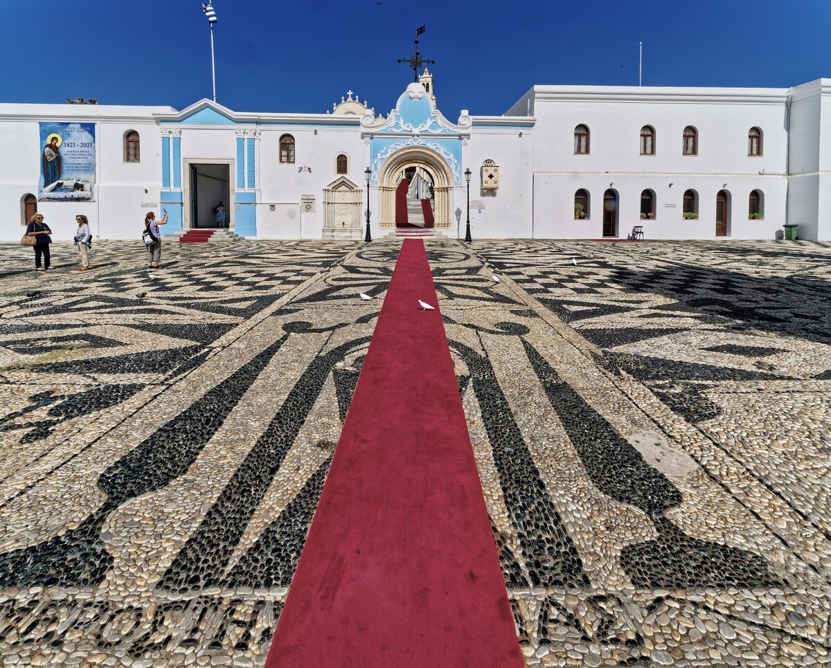 The courtyard of Our Lady of Tinos with its red carpet and black and white mosaic floor