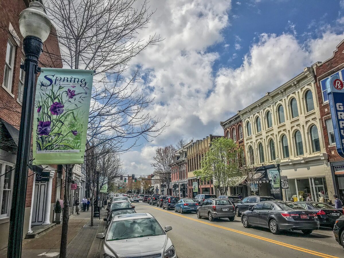 Main Street in downtown Franklin lined with historic brick buildings and spring banners on the lampposts