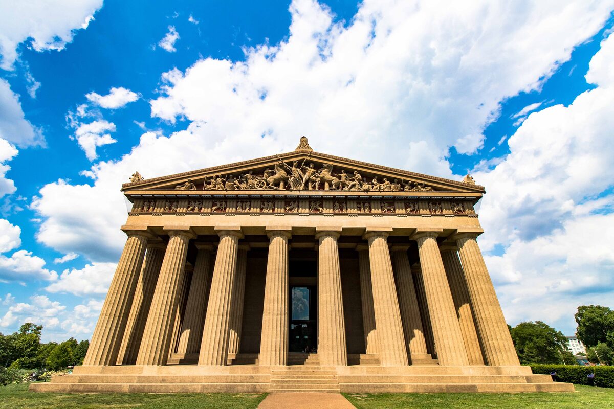 The full-scale Parthenon replica in Centennial Park seen from the front under a blue sky