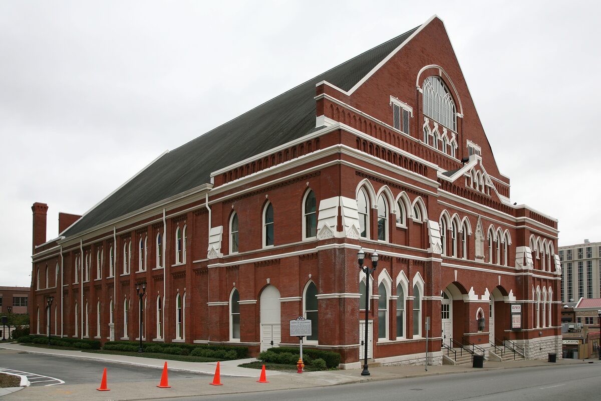 The red brick Ryman Auditorium with its tall arched windows and steep gabled roof