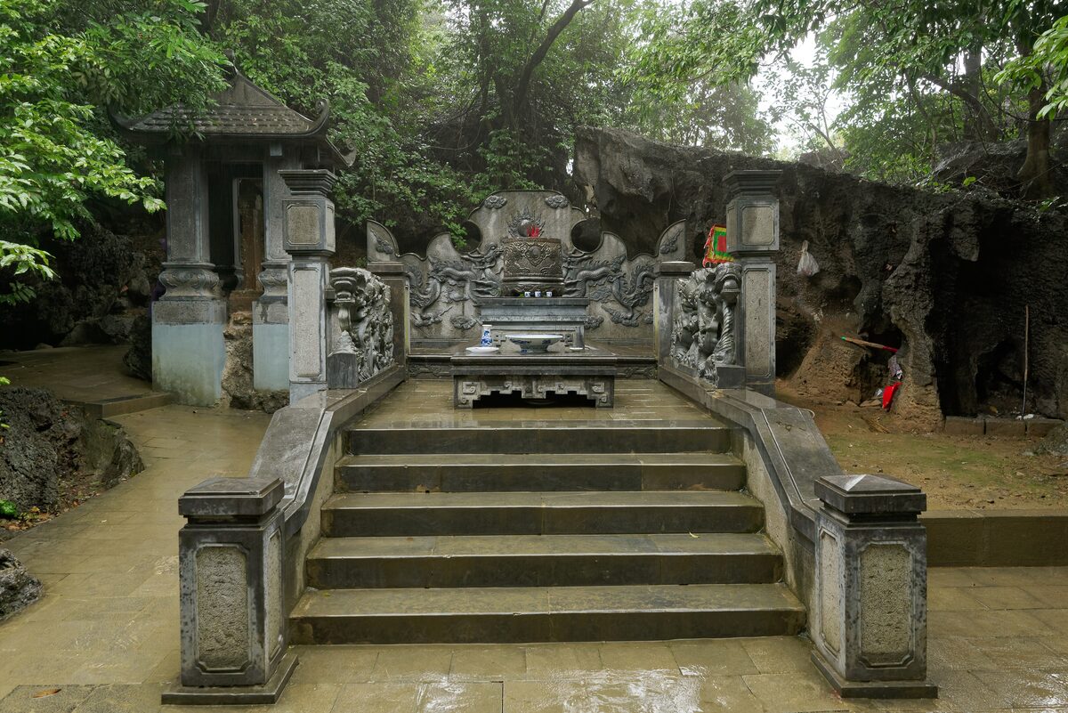 Stone steps leading up to a tomb shrine at the foot of a limestone cliff at Hoa Lu