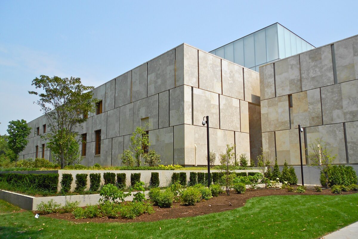 The pale limestone blocks of the Barnes Foundation building above a landscaped garden
