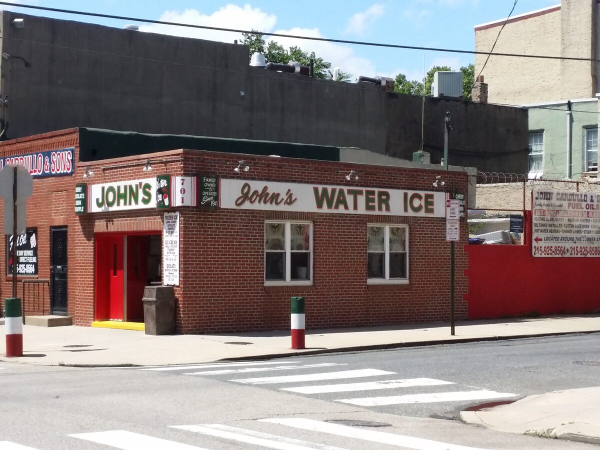 The red-brick John's Water Ice shop on Christian Street on a sunny day
