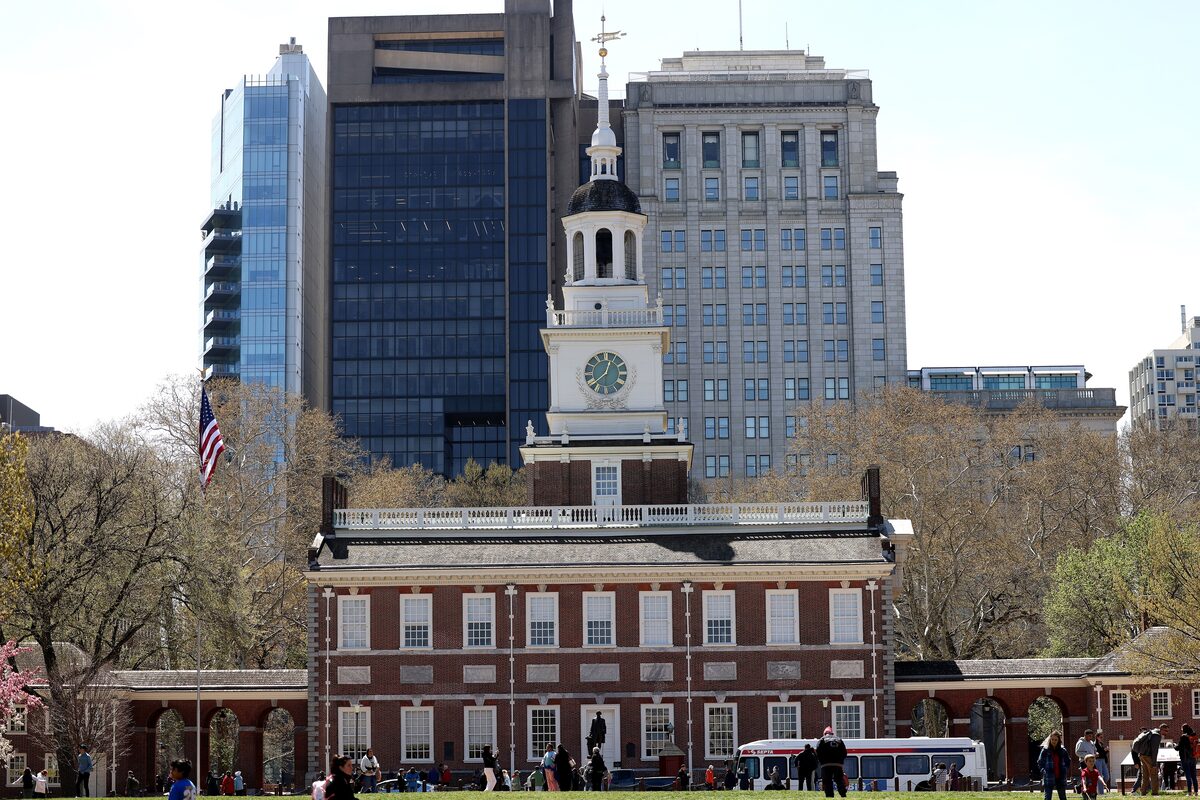 The red-brick Independence Hall and its white clock tower in spring sunshine