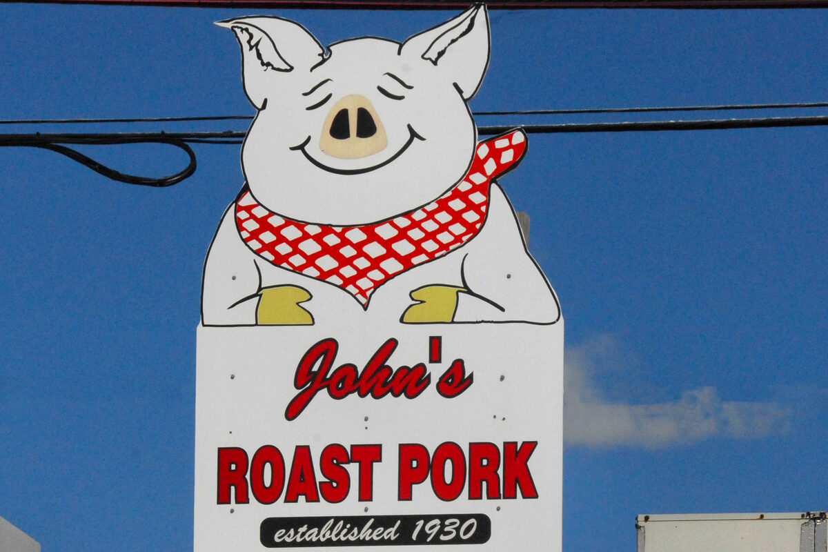 The smiling pig sign of John's Roast Pork, established 1930