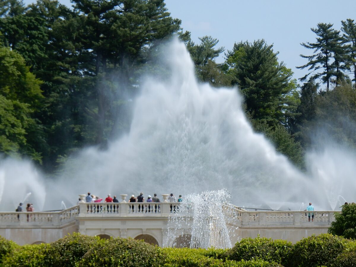 Tall jets of the Main Fountain Garden at Longwood Gardens above visitors