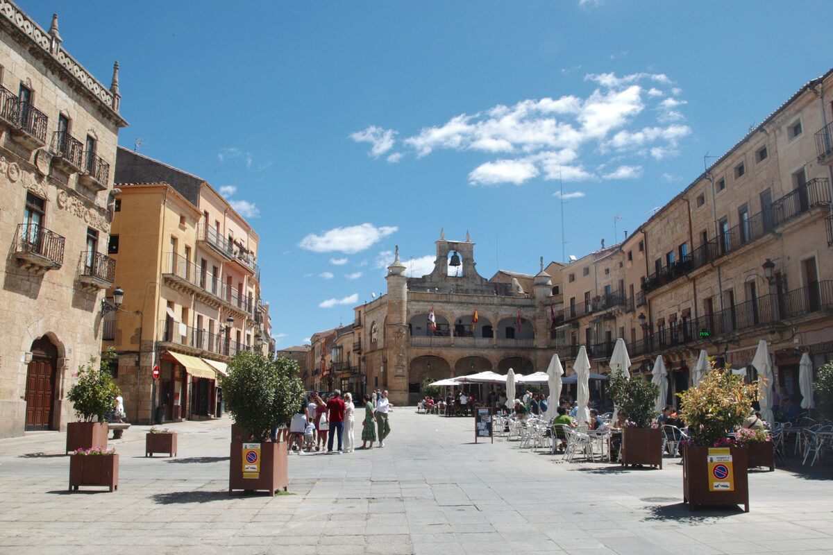 The arcaded Plaza Mayor of Ciudad Rodrigo with café tables and plant boxes