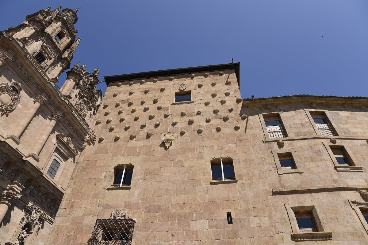 The House of Shells, its walls studded with carved stone scallops under a blue sky