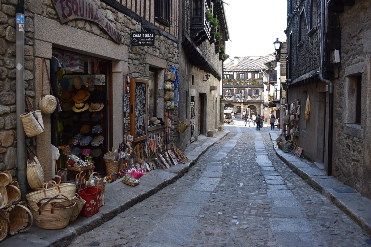 A cobbled street in La Alberca lined with shops selling baskets and wooden goods