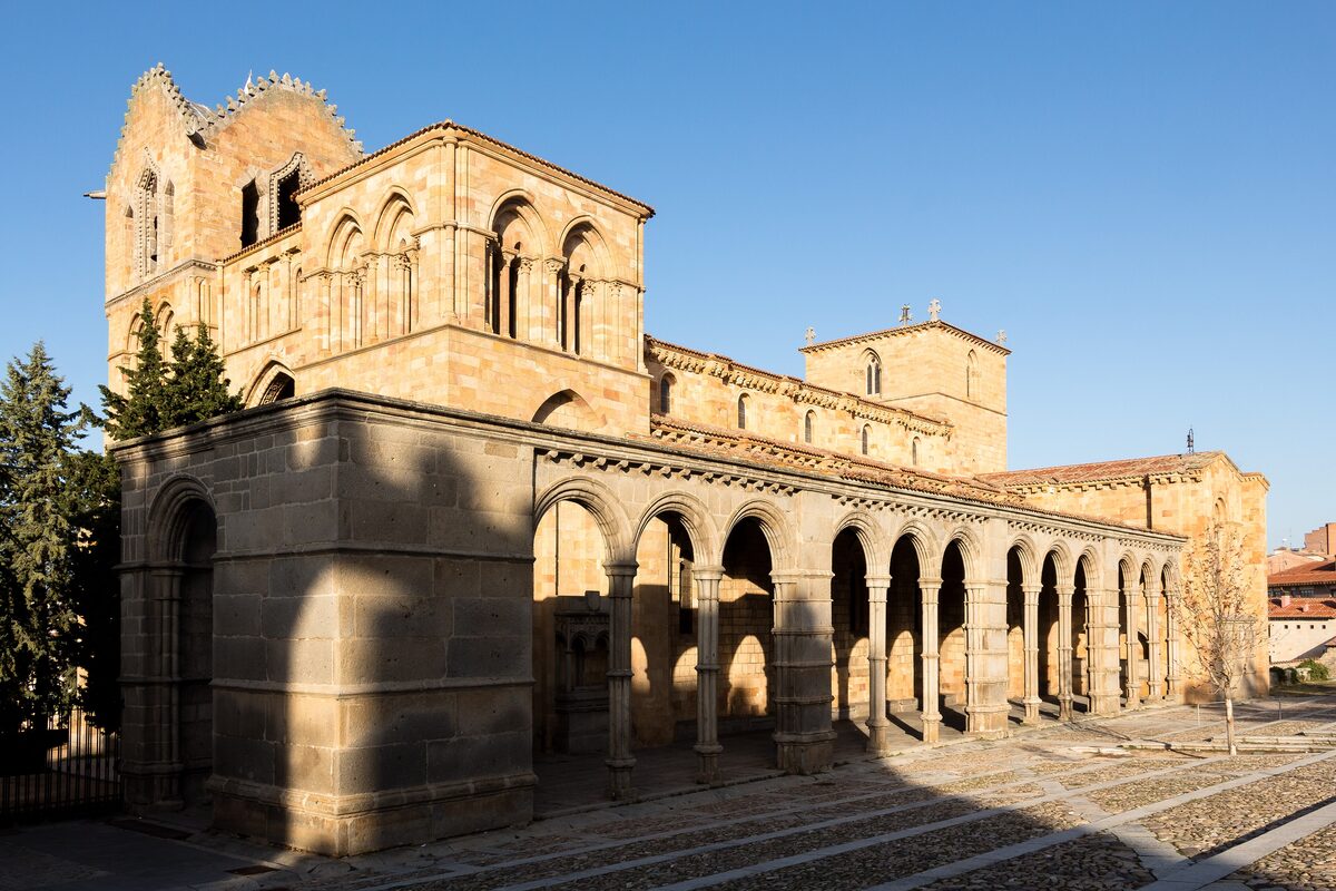 The Romanesque portico and tower of the San Vicente Basilica in warm sun