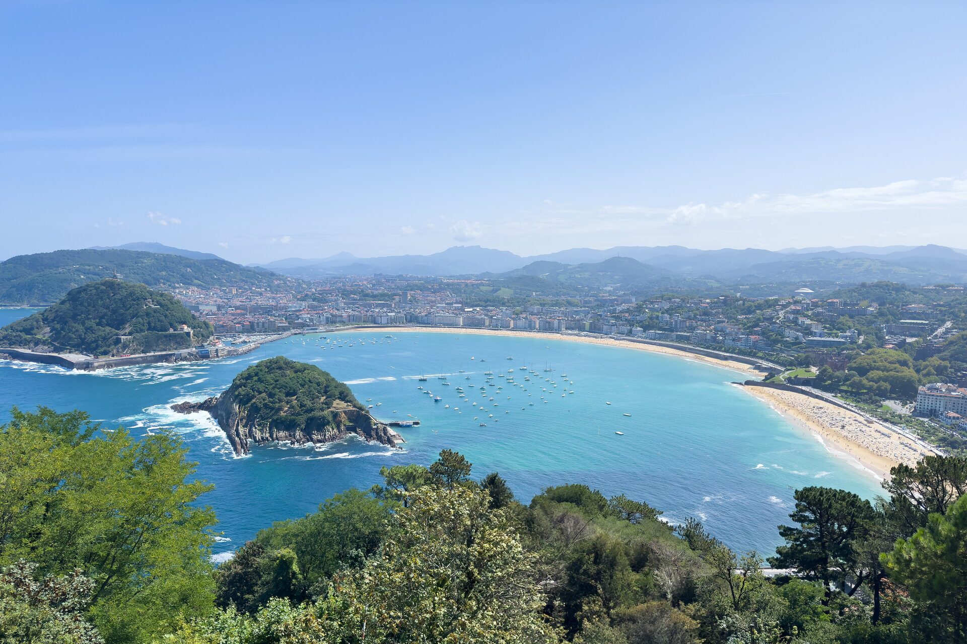La Concha bay seen from Monte Igueldo: the curved beach, Santa Clara island in the middle and Monte Urgull on the left