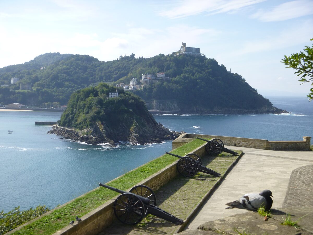 Old cannons on a battery of Monte Urgull, with Santa Clara island and the bay below