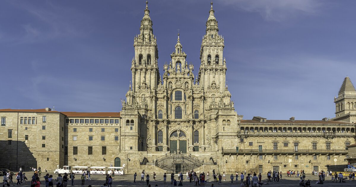 The Baroque Obradoiro facade of Santiago de Compostela Cathedral with its two towers, seen across the square