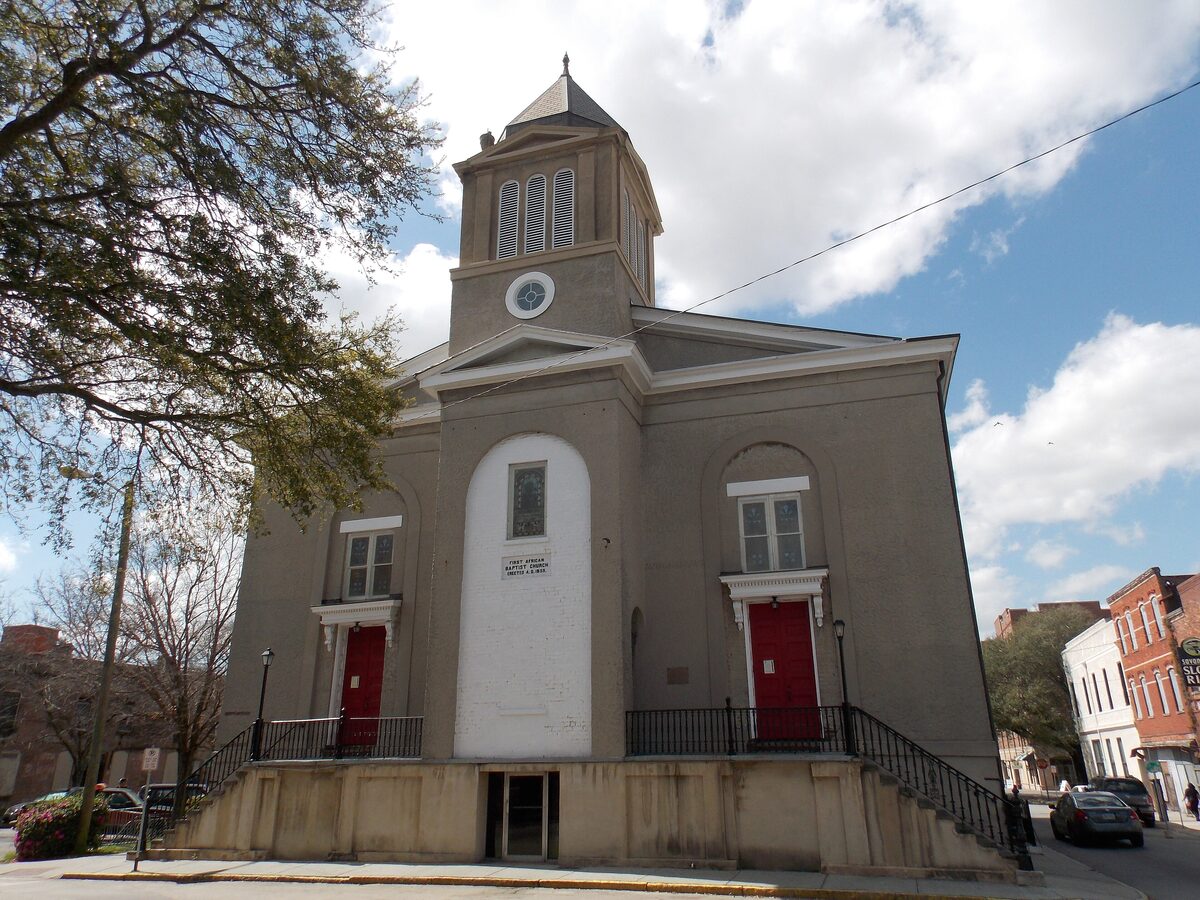 First African Baptist Church, a gray stucco church with red doors