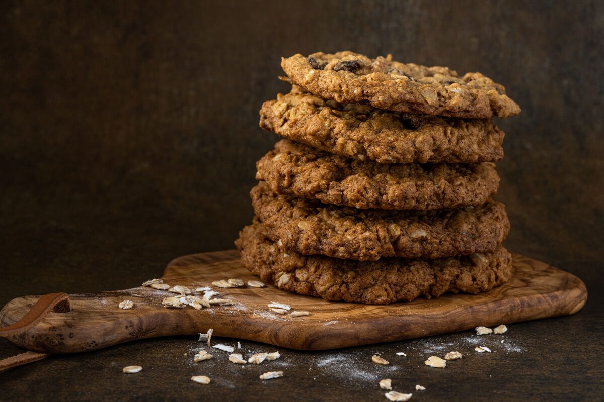 Stack of oatmeal raisin cookies on a wooden board
