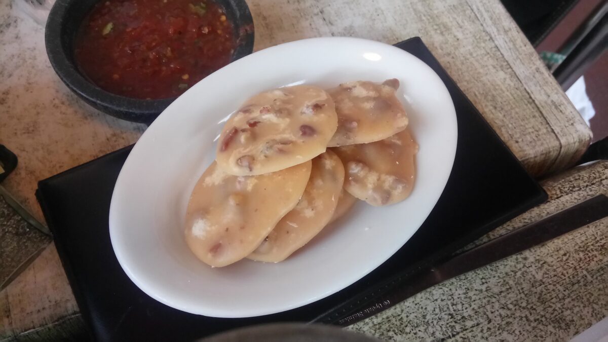 Pecan pralines, soft sugar and nut discs, on a white plate