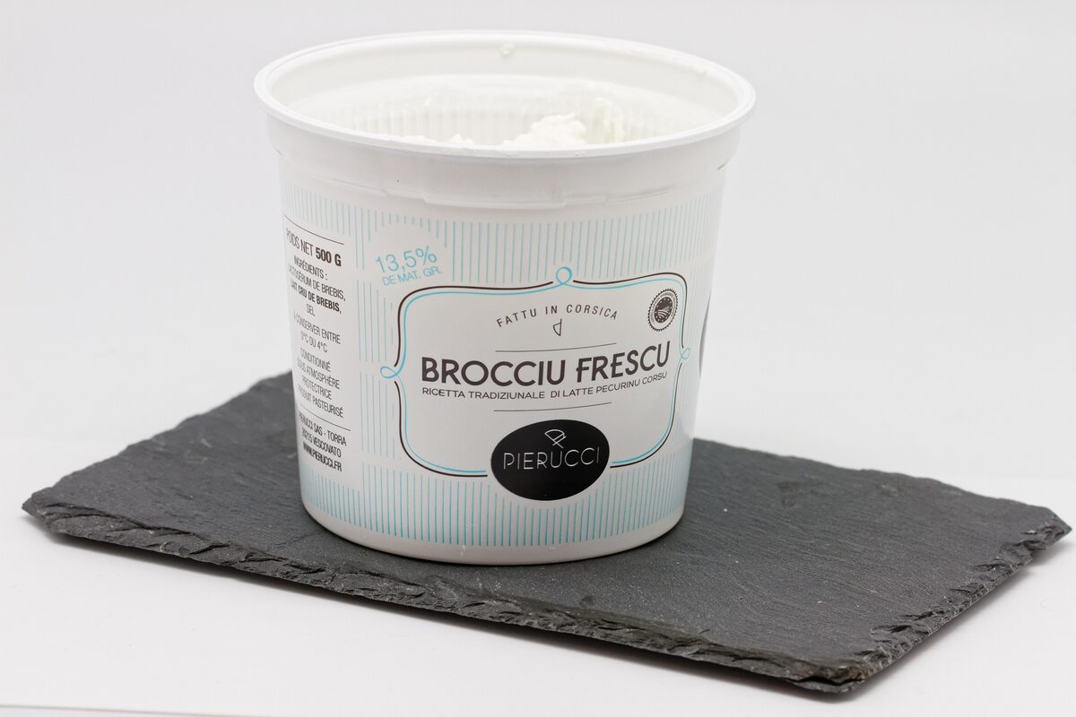 A tub of fresh brocciu cheese on a slate board
