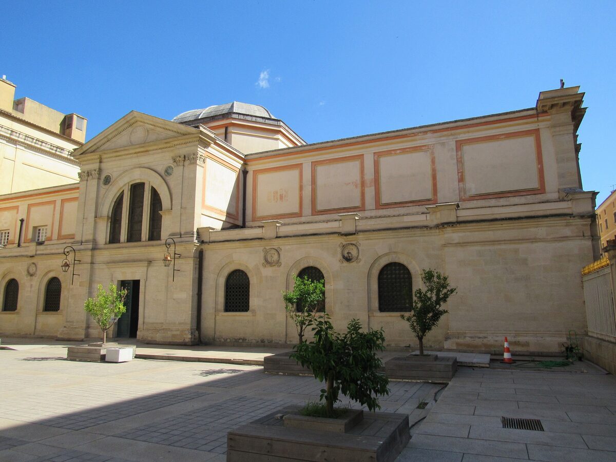 The side of the Chapelle impériale and its paved courtyard, with small trees in wooden planters