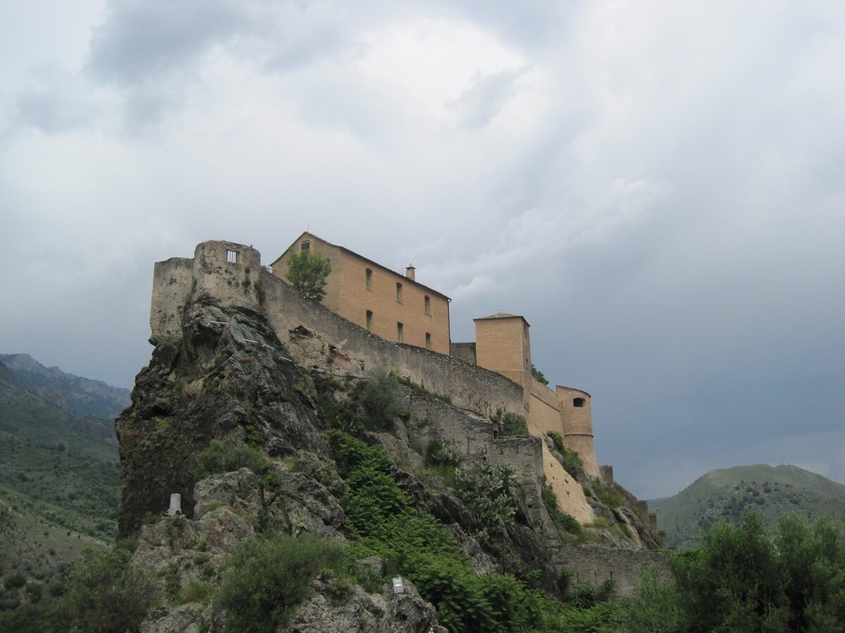The citadel of Corte on its rock above the town, under a grey sky