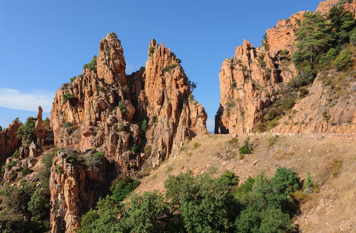 The red granite spires of the Calanques de Piana rising above the sea