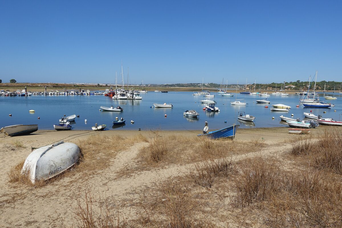 Fishing boats in the Ria de Alvor lagoon at low tide