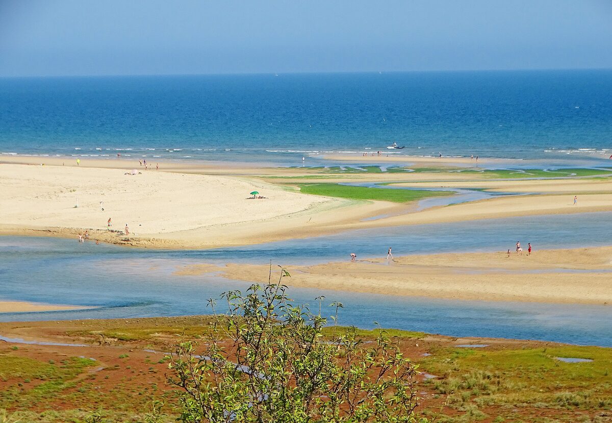 The Ria Formosa lagoon at Cacela Velha with sandbanks, tidal channels and the sea beyond, seen from the village