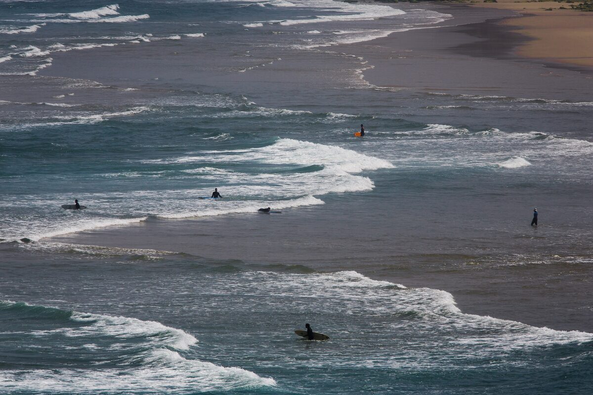 Surfers riding the waves off the Carrapateira coast