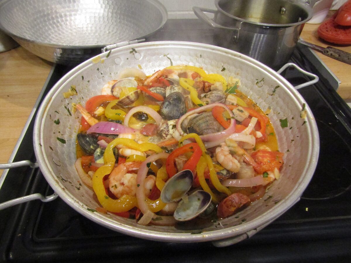 Clams and peppers stewed in a steel cataplana pan