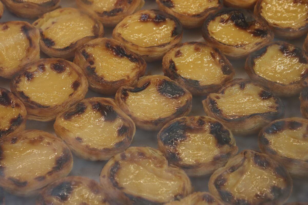 Rows of pastéis de nata with blistered tops