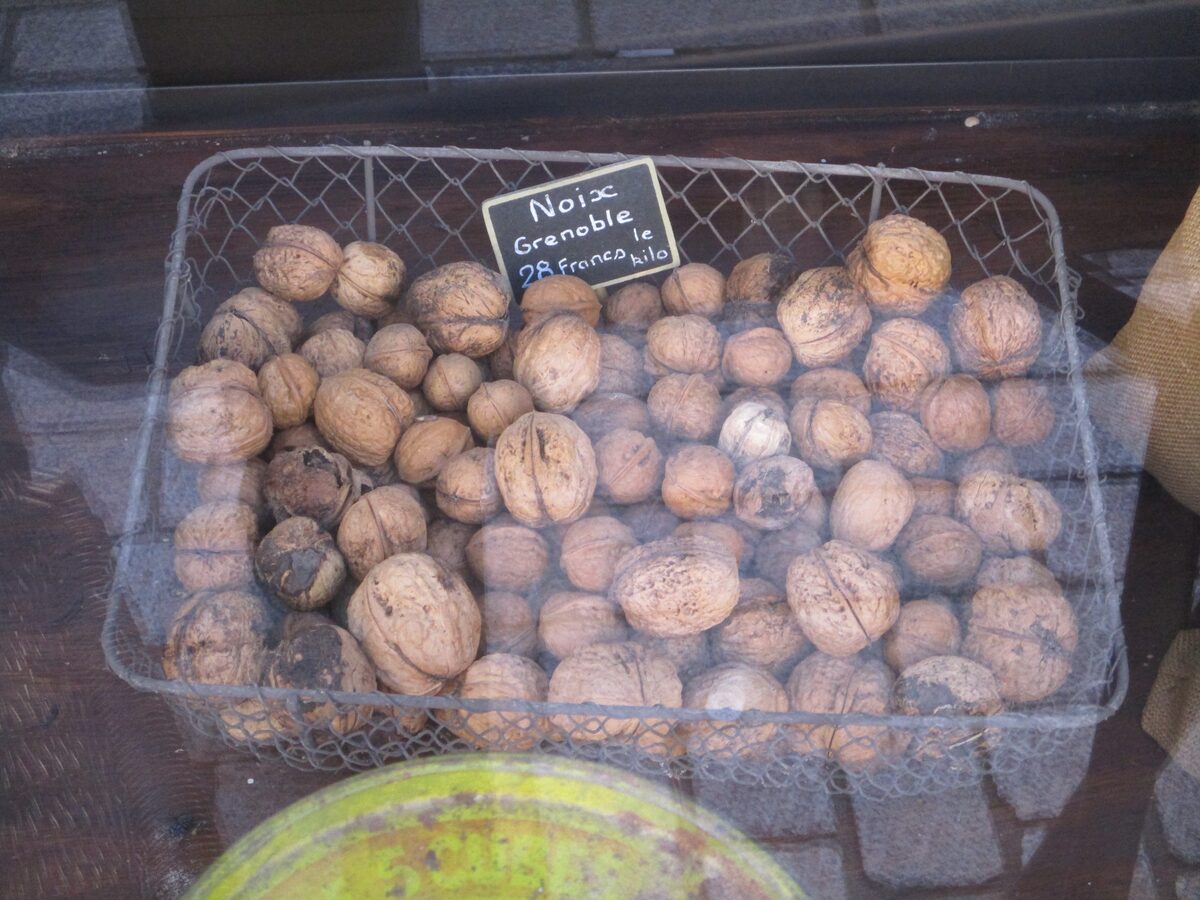 Walnuts in a wire basket with a Noix de Grenoble label