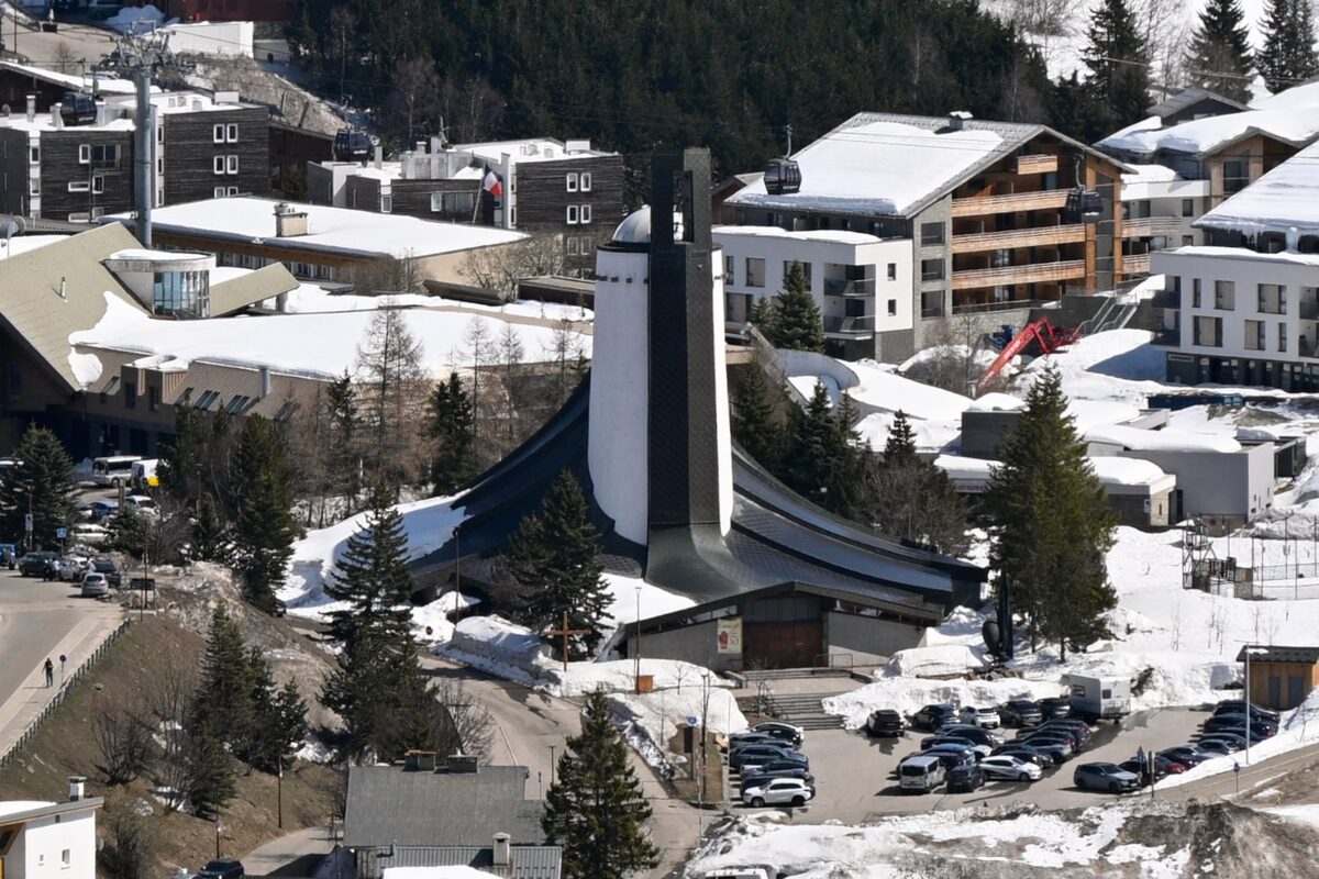 The Notre-Dame-des-Neiges church and the snowy car park of Alpe d'Huez, seen from above