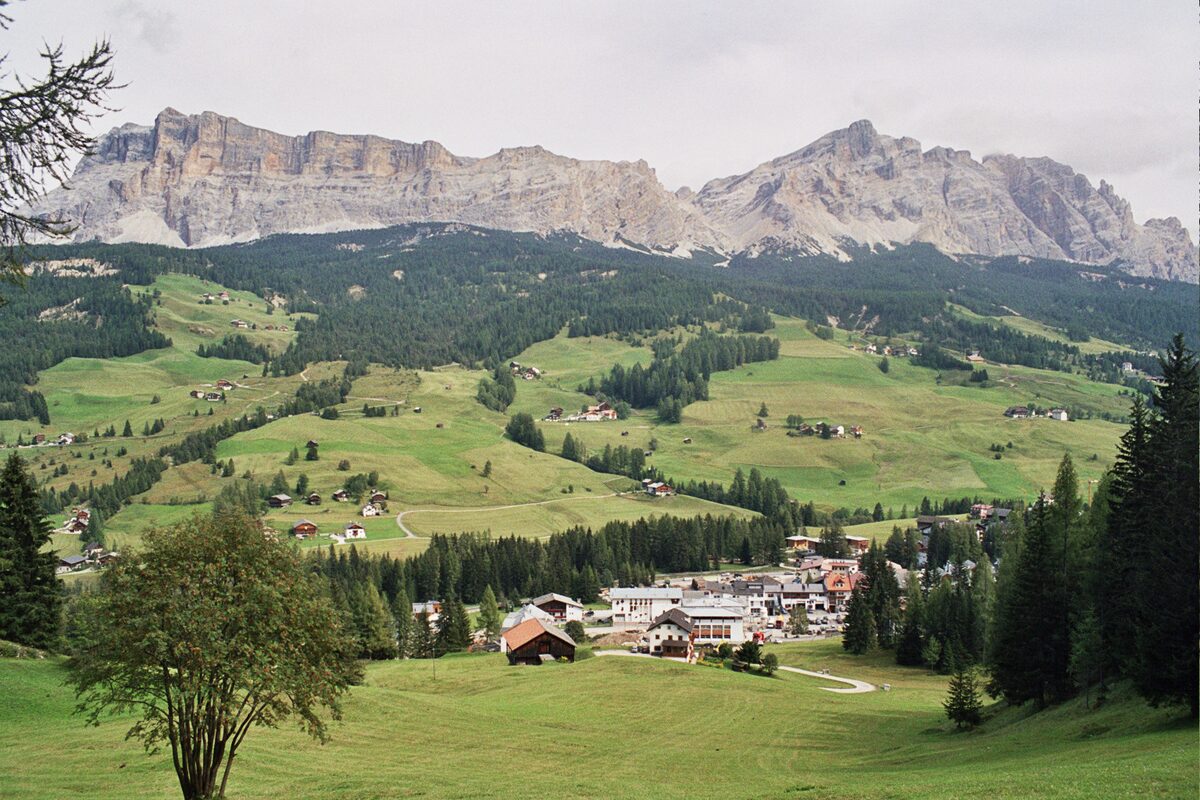Summer view of La Villa (La Ila), a village among green meadows under the Gardenazza plateau