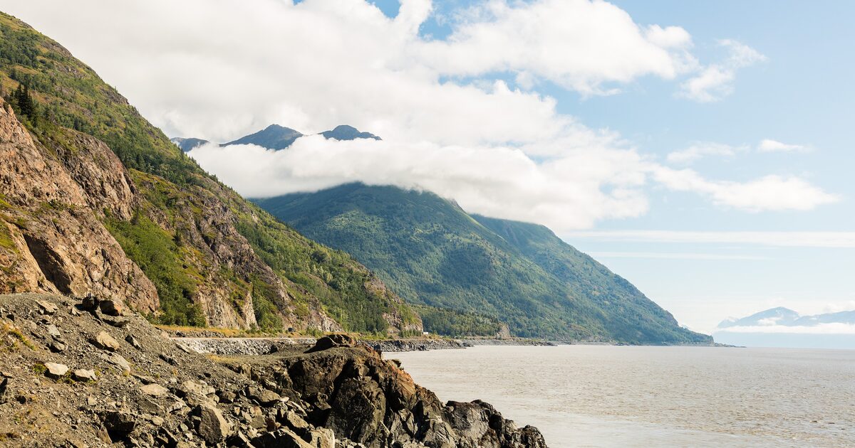 Turnagain Arm at low tide with the Chugach Mountains rising above the Seward Highway