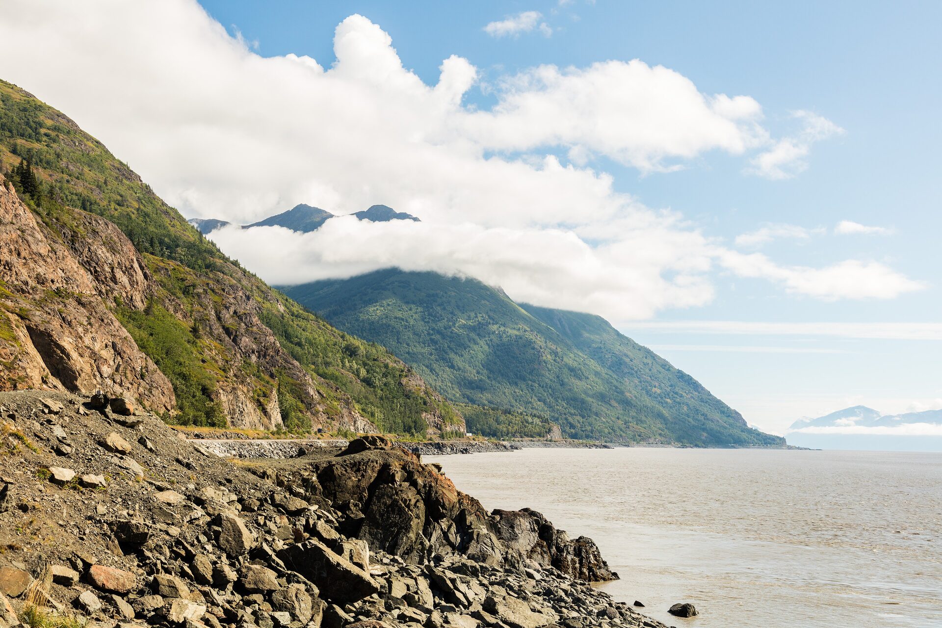 Turnagain Arm at low tide with the Chugach Mountains rising above the Seward Highway