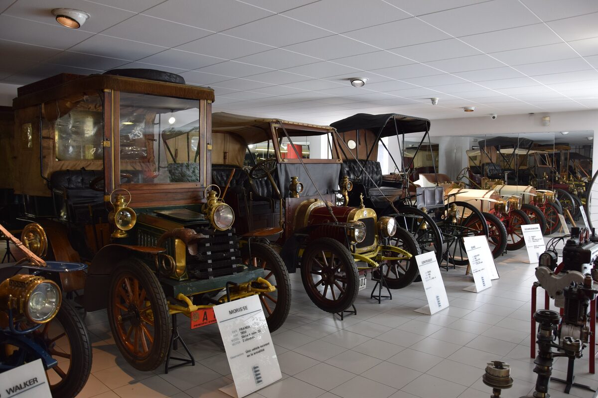 Early motor cars with brass lamps and open bodies on display in the National Automobile Museum in Encamp