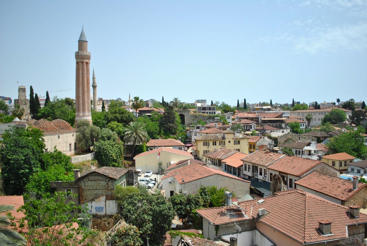 The fluted brick Yivli Minaret rising over the red-tiled roofs and trees of Kaleiçi