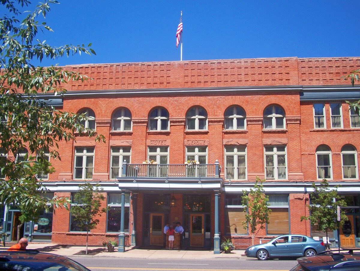The red-brick front of Hotel Jerome on Main Street in Aspen, with its balcony and arched windows
