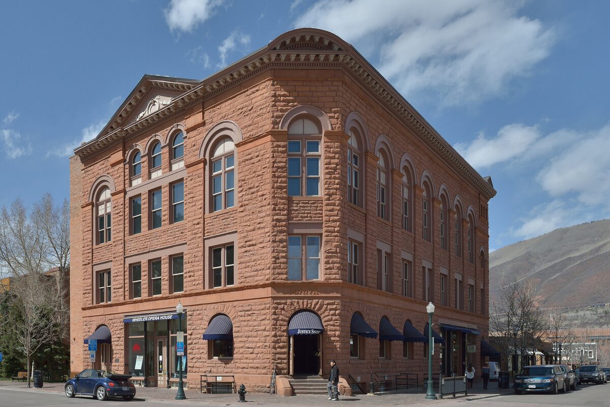 The Wheeler Opera House in Aspen, a three-storey red sandstone building with arched windows on a street corner