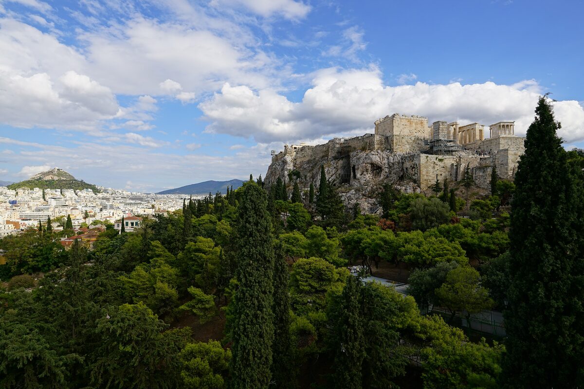 The view from Areopagus Hill over cypresses and pines to the Acropolis walls, with Lycabettus Hill on the left