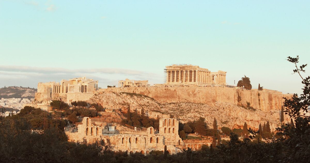 The Acropolis in warm late-afternoon light, with the Propylaea, the Erechtheion and the Parthenon above the Odeon of Herodes Atticus