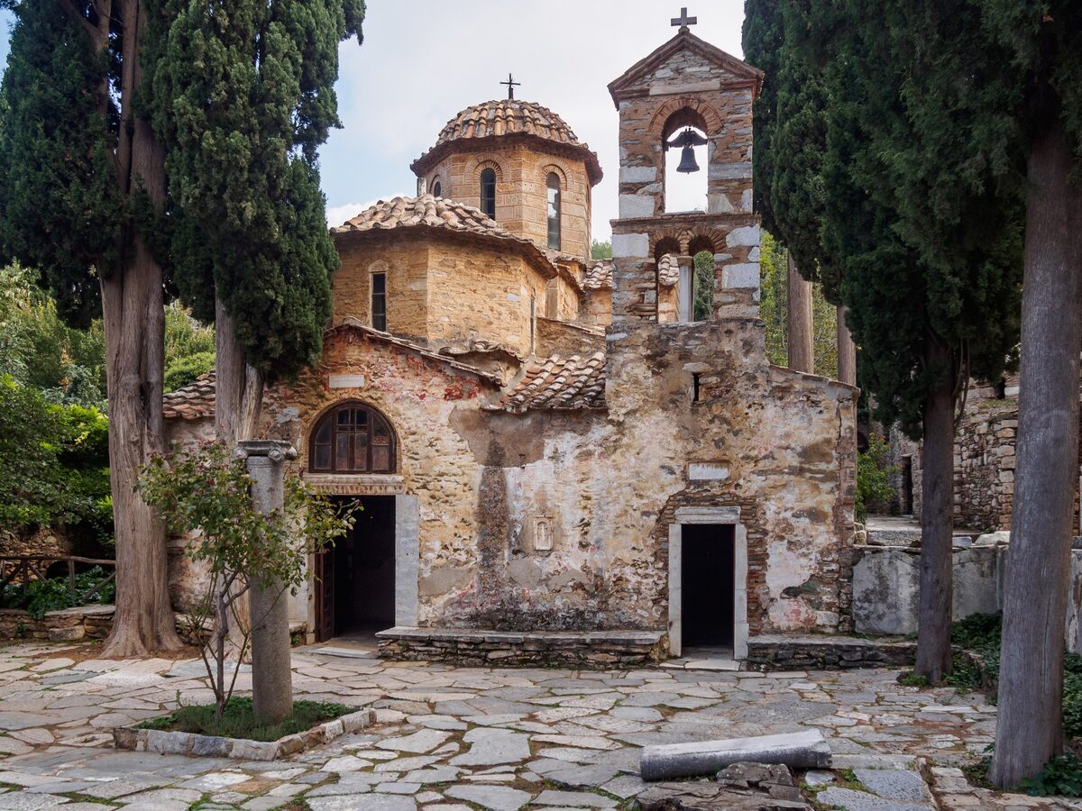 The Byzantine church of Kaisariani Monastery with its dome and bell tower, framed by tall cypresses