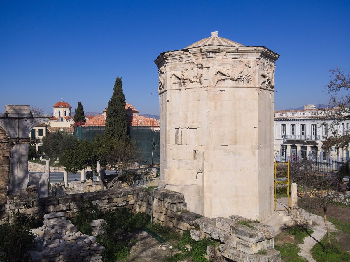 The octagonal marble Tower of the Winds with its frieze of wind gods, beside the ruins of the Roman Agora