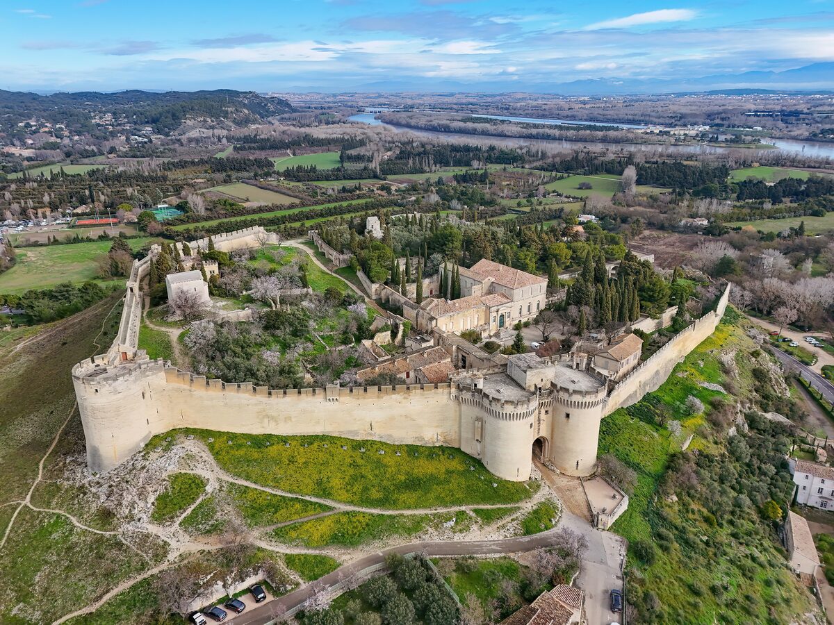 Aerial view of the Fort Saint-André walls and towers on a hill above Villeneuve-lès-Avignon, with the Rhône plain behind