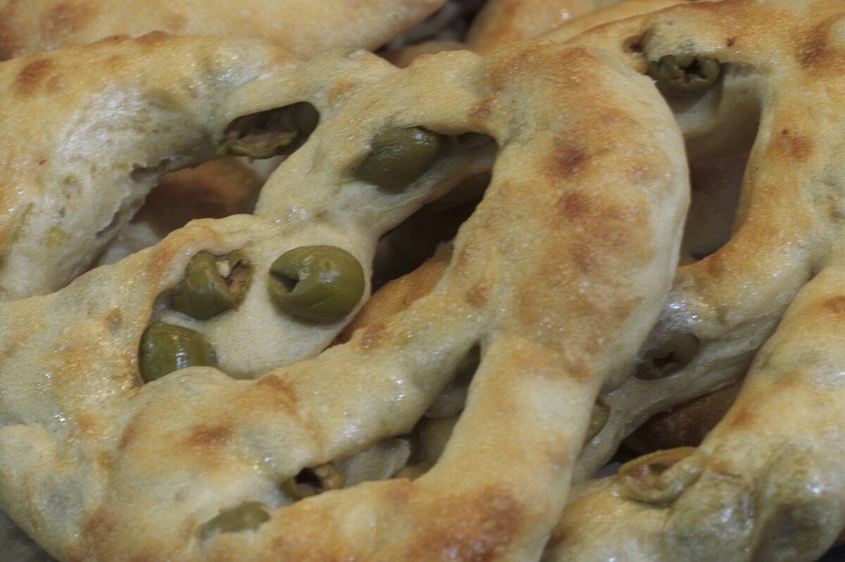 Fougasse, a flat Provençal bread with green olives pressed into its open-cut surface