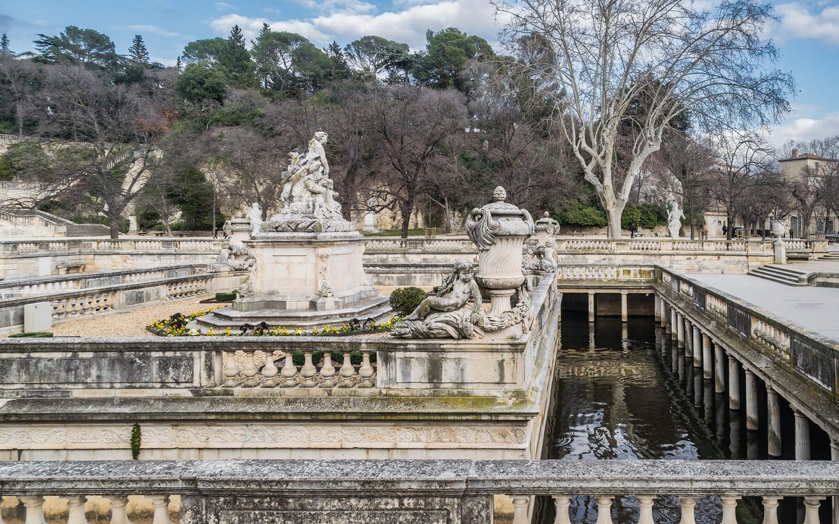 Stone terraces, statues and a long water channel in the Jardins de la Fontaine in Nîmes