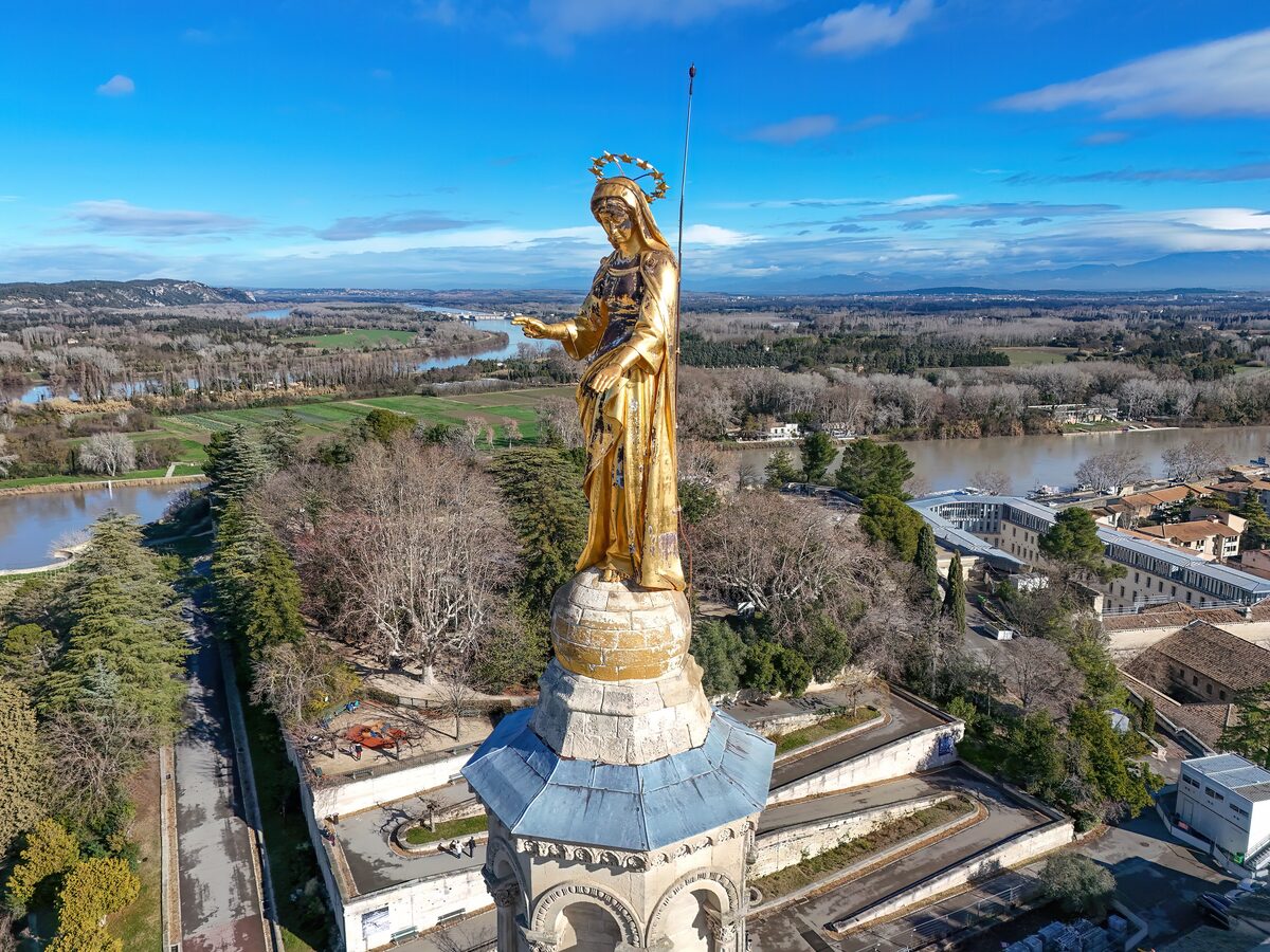 The gilded statue of the Virgin Mary above the cathedral, seen from the air with the Rhône plain beyond